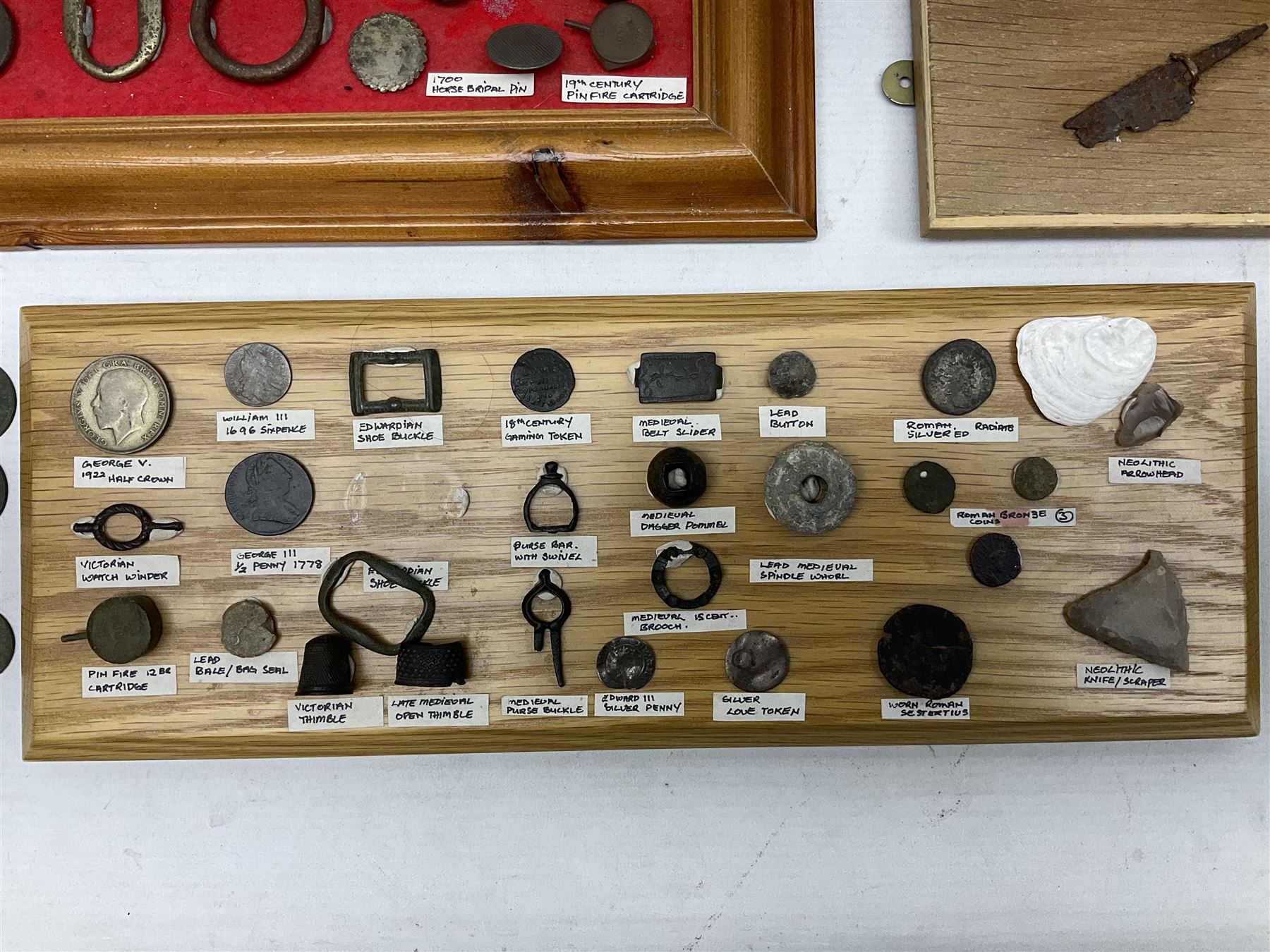 Collection of metal detecting finds and antiquities, housed on five display boards and some loose, to include coins, keys, axe head etc 