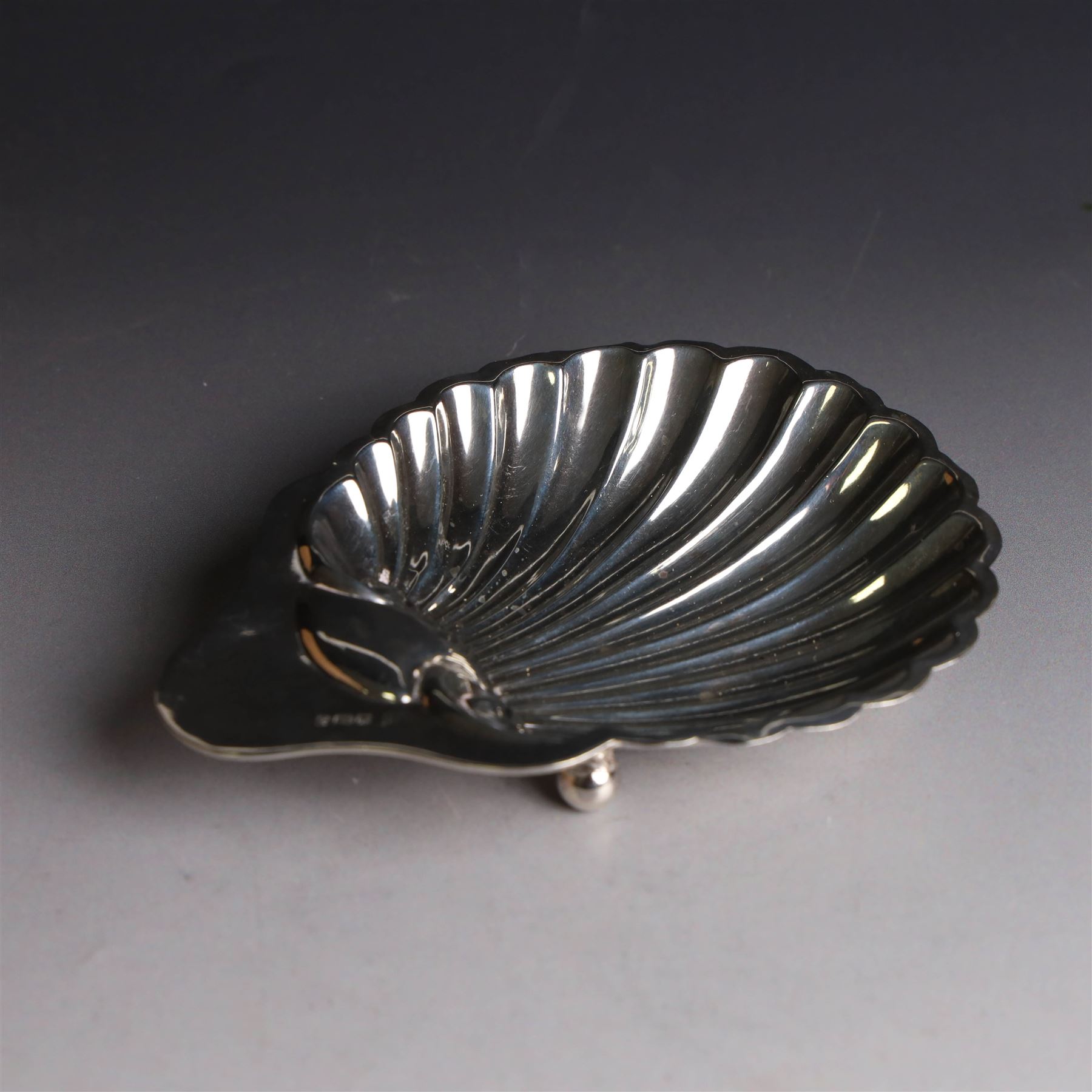 Edwardian silver clam shell butter dish, upon three bun feet, hallmarked James Deakin & Sons, Sheffield 1910
