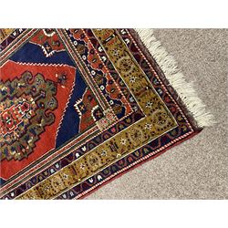 Turkish Taspinar rug, blue ground with central lozenge and medallion, the outer borders decorated with stylised motifs