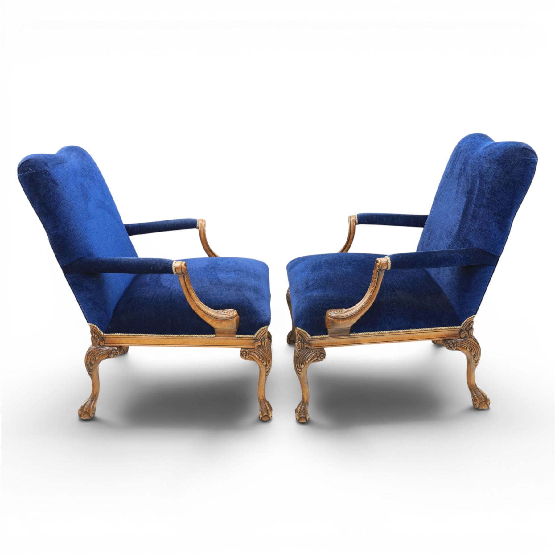 Pair of George II design Gainsborough armchairs in deep blue upholstery, shaped back over scrolled and carved arms, with cabriole supports and carved shell knees terminating in claw on ball feet