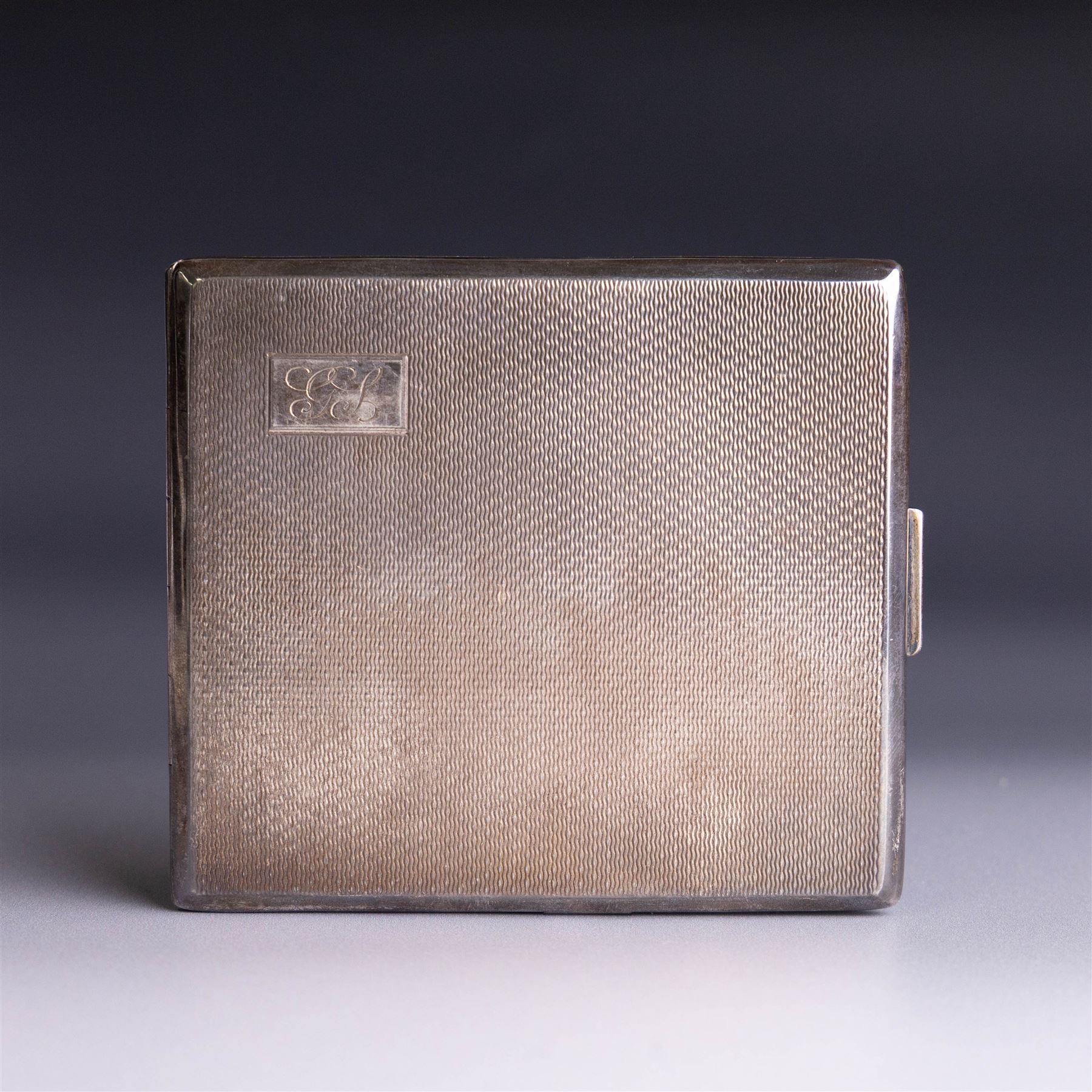 Mid 20th century silver cigarette case, with engine turned decoration and engraved initials to cover, with presentation engraving to the interior, hallmarked Harman Brothers, Birmingham 1947, H8.5cm, W9.5cm