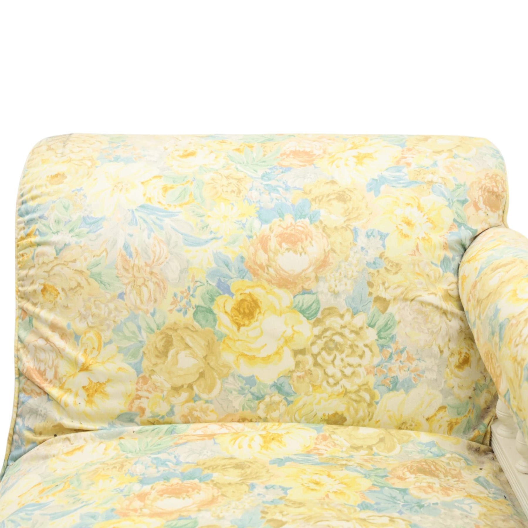 Victorian chaise longue in chintz upholstery, scrolled back with turned spindles up, raised on castors