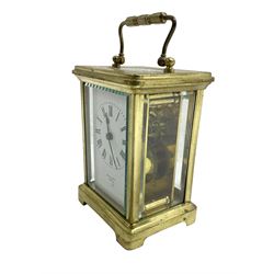 French - 20th century timepiece carriage clock, in a corniche case with carrying handle, enamel dial with Roman numerals, minute track, spade hands and retailers name “Mallory, Bath”, cylinder platform escapement, wound and set from the rear.