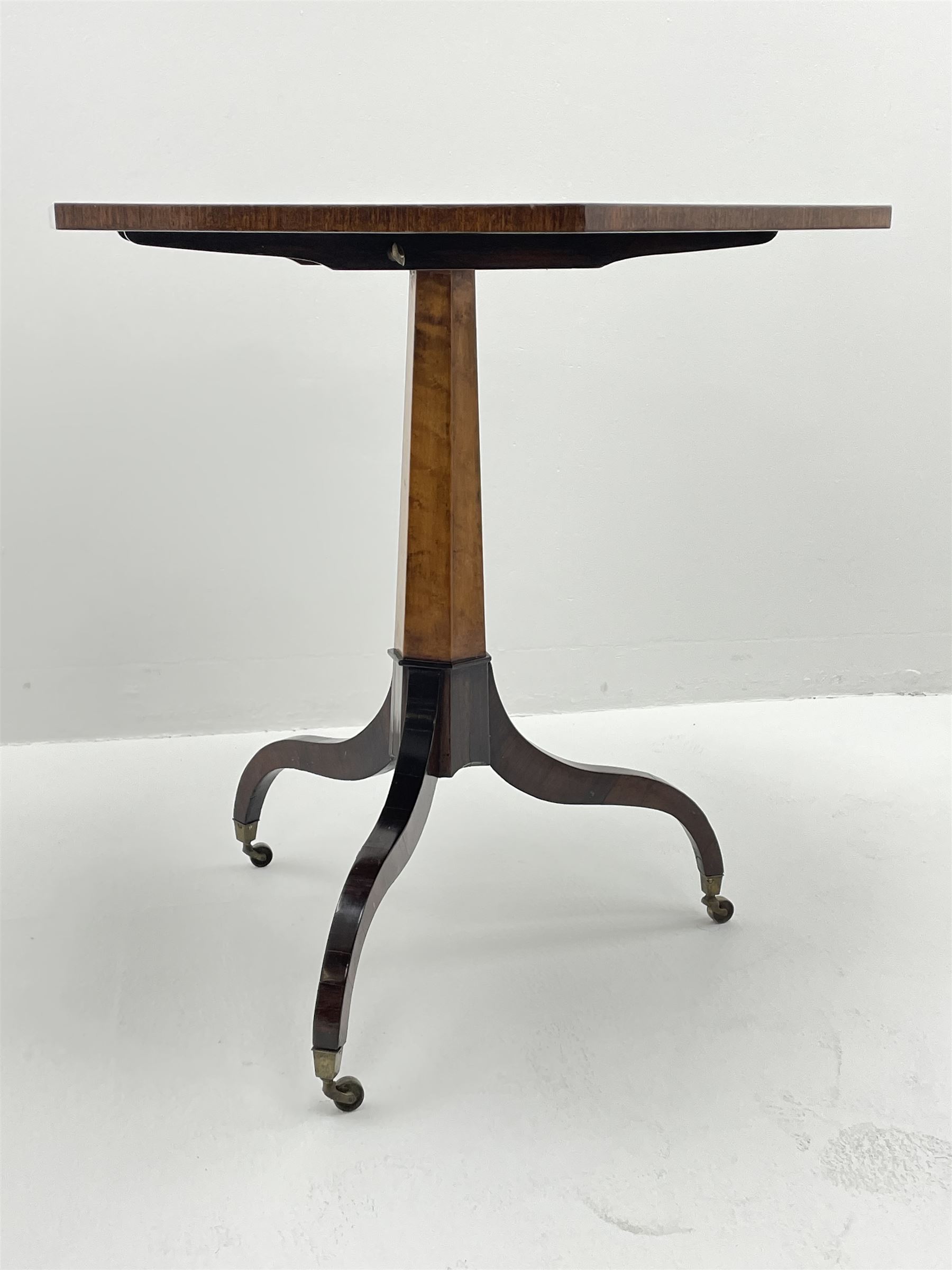 Regency style birdseye maple and rosewood tripod table, hexagonal tilt top with segmented veneer and banding, tapered hexagonal column on three splayed serpentine supports, brass cups and castors 