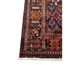 Persian Joshaghan red ground rug, stepped lozenge medallion surrounded by small lozenge motifs, the border decorated with stylised plant motifs within patterned guard stripes