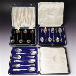 Set of six silver coffee spoons with shaped terminals, cased London 1924, another set of s...