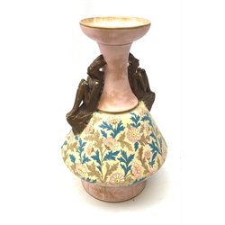 A late 19th century Aesthetic Movement Old Hall vase designed by Christopher Dresser, the flared body decorated with stylised flowering vines, leading to a tapering neck and flared rim with twin figural handles (one s/d), and raised upon a circular footed base, with printed mark beneath, H35cm. 