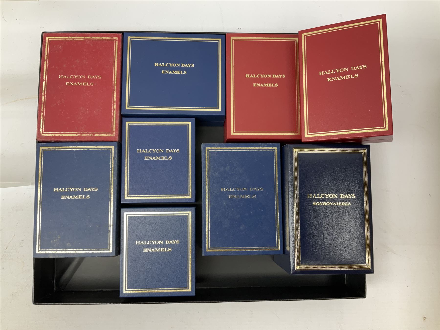 Eight Christmas themed Halcyon Days enamel boxes, and a Halcyon Days enamel bonbonniere modelled as a snowman, each in fitted box 