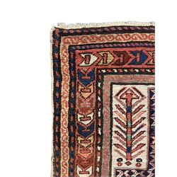 Old Caucasian rug, neural ground field decorated with three geometric medallions surrounded by stylised bird and flower head motifs, multiple border bands with geometric repeating design