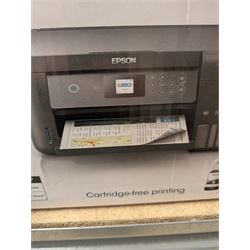 Epson ET-2750 ecotank printer, boxed with a collection of printing paper including photographic paper and postcards