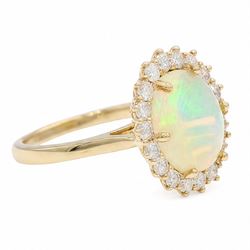 9ct gold opal and diamond cluster ring, single cabochon cut opal of approx 1.95 carat, surrounded by eighteen round brilliant cut diamonds, total diamond weight approx 0.80 carat