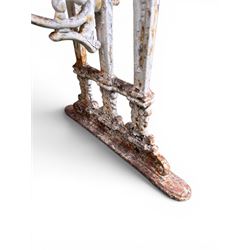 Victorian cast iron garden table, rectangular slate top raised on pierced scrolling foliate end supports with urn and column designs, united by a spindle support stretcher with scrolling acanthus spandrels, stamped 'Registered Design' with indistinct number, in distressed white painted finish