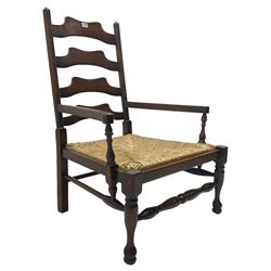 Georgian design oak country low armchair, waived ladder back over rush seat, raised on turned  supports united by stretchers; together with matching stool