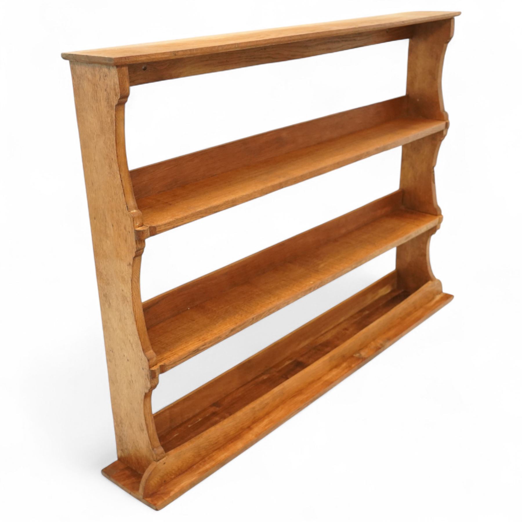 Gnomeman - oak plate rack, rectangular moulded top over three open plate shelves with raised front rails, shaped and chamfered upright supports, stepped base plinth, signature carved Gnome by Thomas Whittaker of Littlebeck