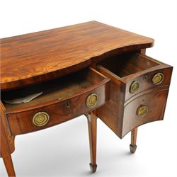 George III inlaid mahogany serpentine sideboard, the shaped top with crossbanding and satinwood stringing, fitted with central bow-front cock-beaded frieze drawer over a shaped apron inlaid with paterae, shell motifs and scrolling foliage, flanked by a deep right-hand drawer and two drawers to the left, raised on square tapering supports with spade feet