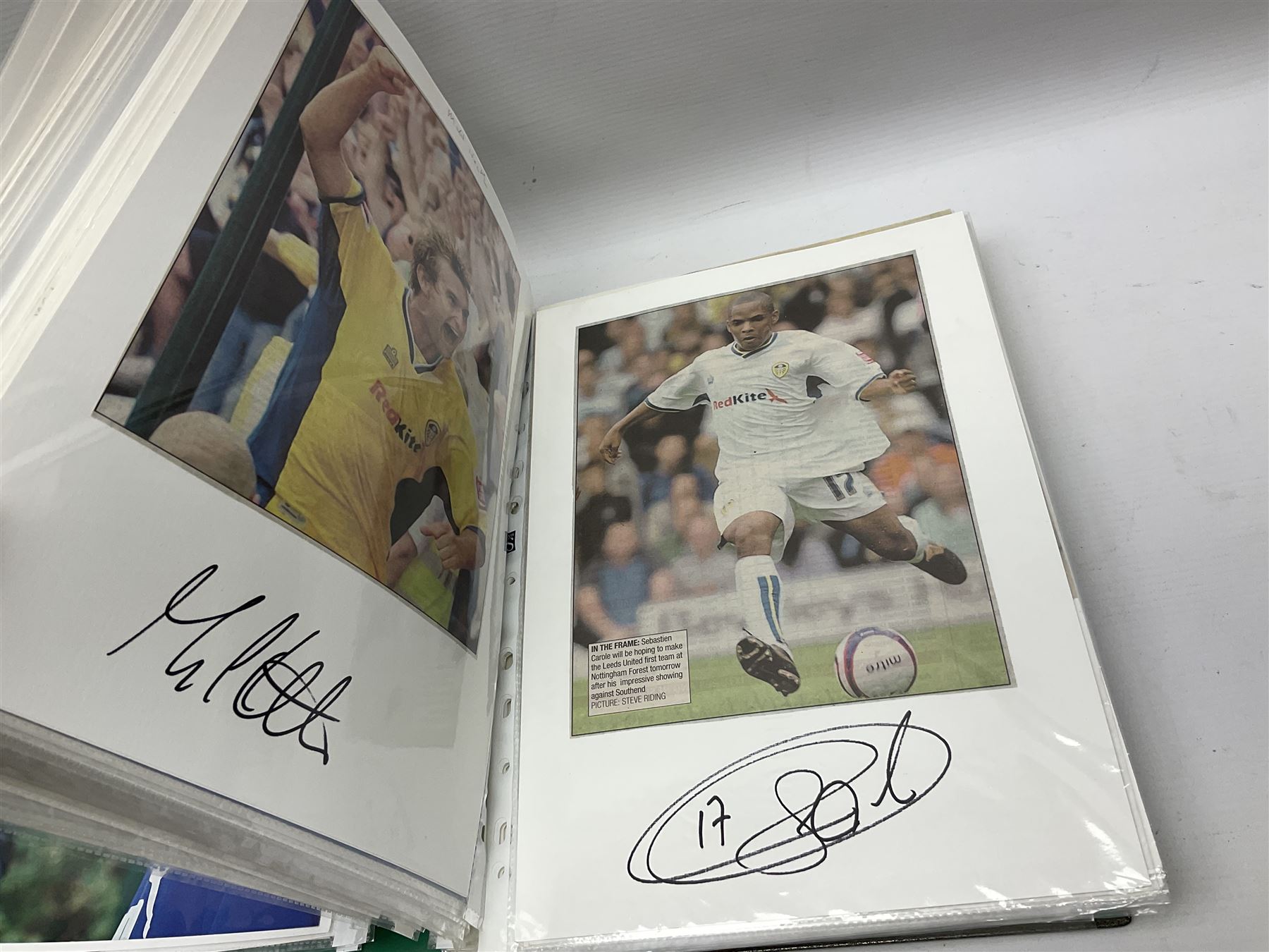 Collection of approximately 200 Leeds United related autographs, predominantly signed newspaper cuttings, contained within ring binder, together with a number of loose examples
