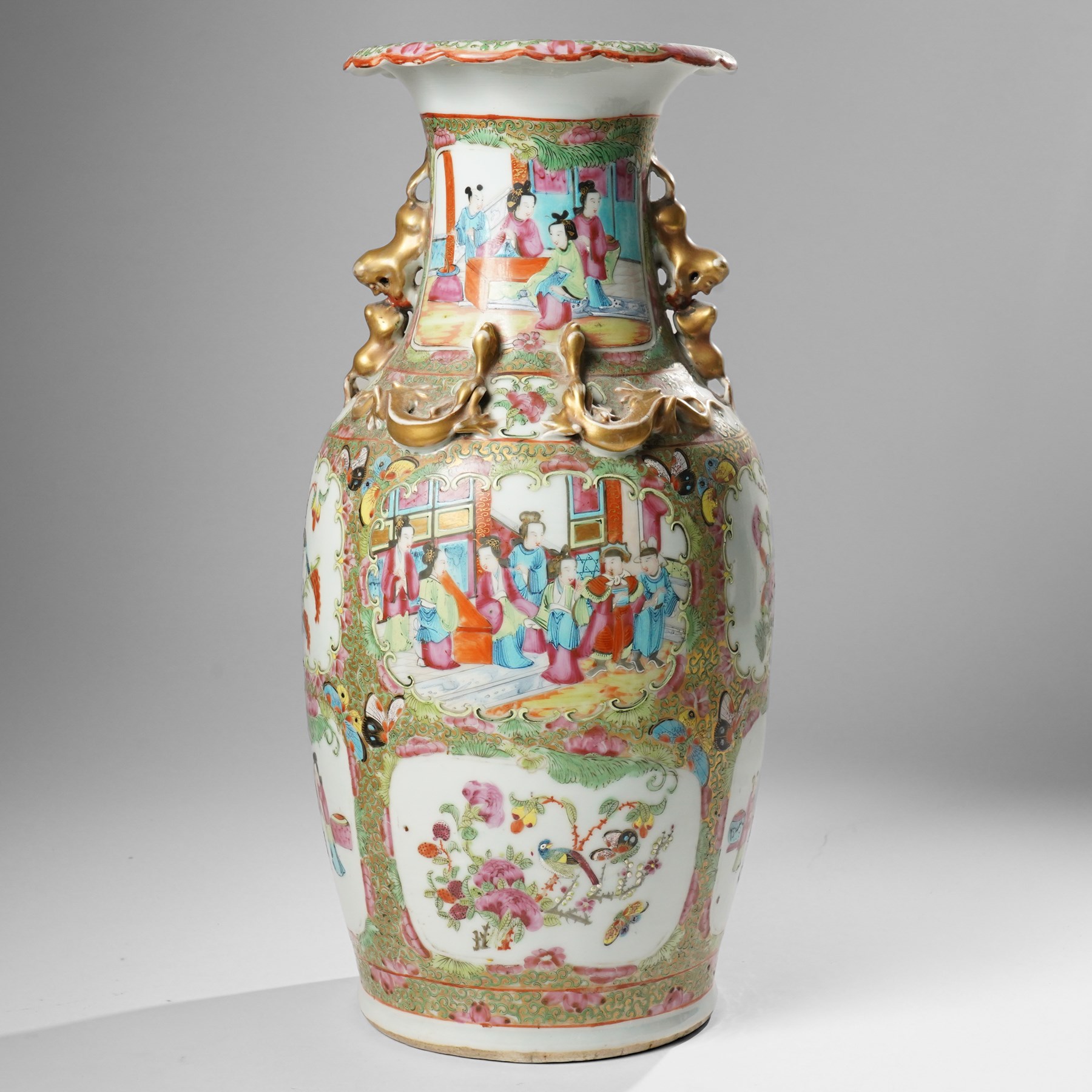 Cantonese famille rose vases, of inverted baluster form, the domed cover with gilt dog of Fu finial, H38cm; together with a further pair of Cantonese vases, each with double Buddhist lion handles and applied at the shoulders with chilong, H45cm (3)