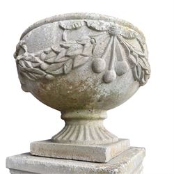 Pair of quality Neoclassical design Haddonstone cast stone garden urns, the globular  body decorated with relief foliate festoons and fruiting motifs, over a fluted socle, the rectangular pedestals with relief foliate wreaths and ribbon garlands