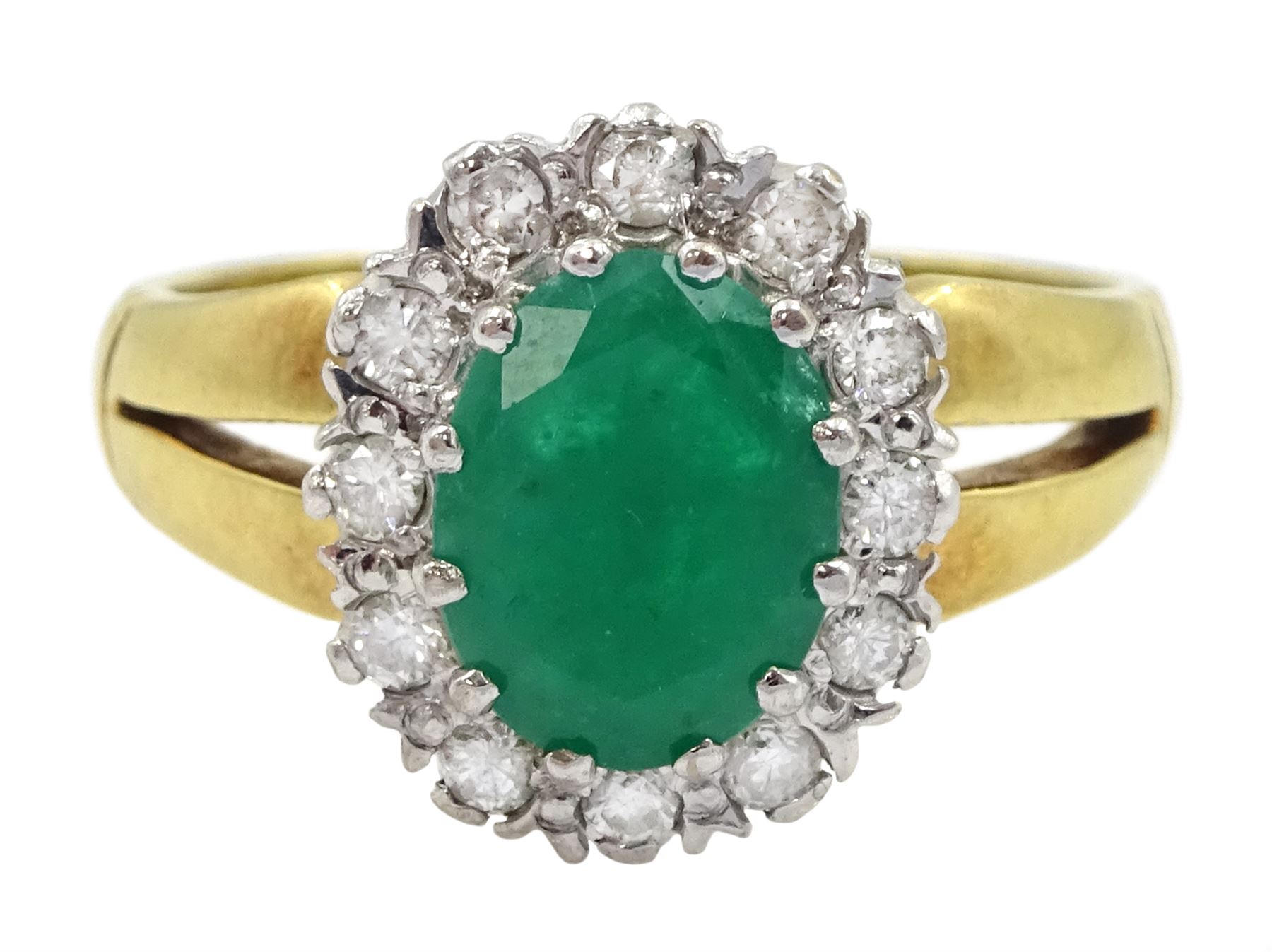 18ct gold oval emerald and round brilliant cut diamond cluster ring, London 1979