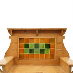 Arts & Crafts pine kitchen cabinet, raised tiled back with projecting shelf and shaped side supports, rectangular work surface above single cupboard door with moulded panel, on square supports
