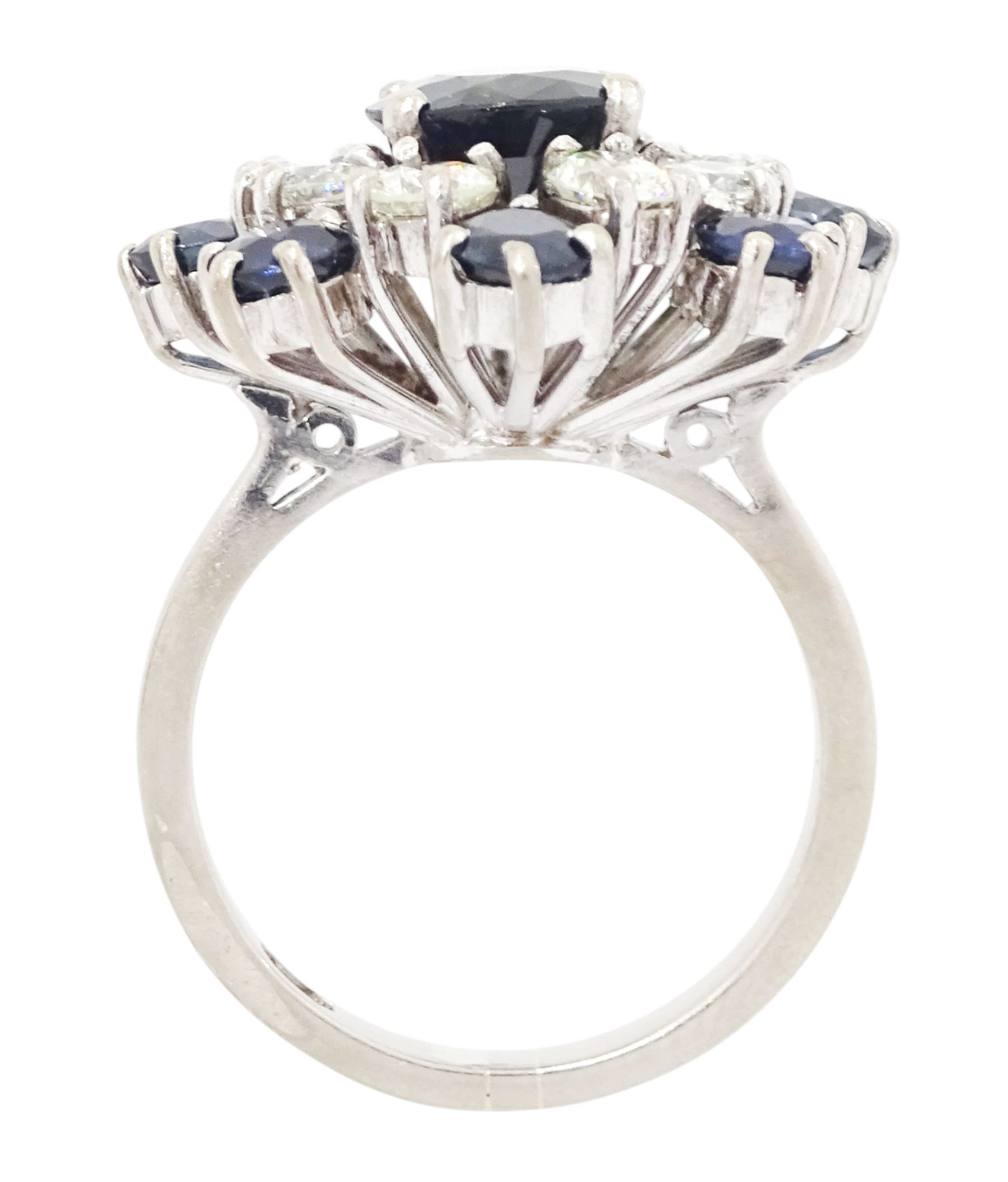 18ct white gold sapphire and diamond cluster ring, single oval cut sapphire of approx 1.85 carat, surrounded by eight round brilliant cut diamonds and eight round cut sapphires, stamped Graff, total sapphire weight approx 3.40 carat, total diamond weight approx 1.35 carat