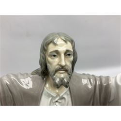 Lladro figure, The Loaves and Fishes, modelled as Jesus Christ with arms raised standing beside a basket of loaves and a basket of fish, sculpted by Salvador Furió, with original box, no 5896, year issued 1992, year retired 1997, H35cm
