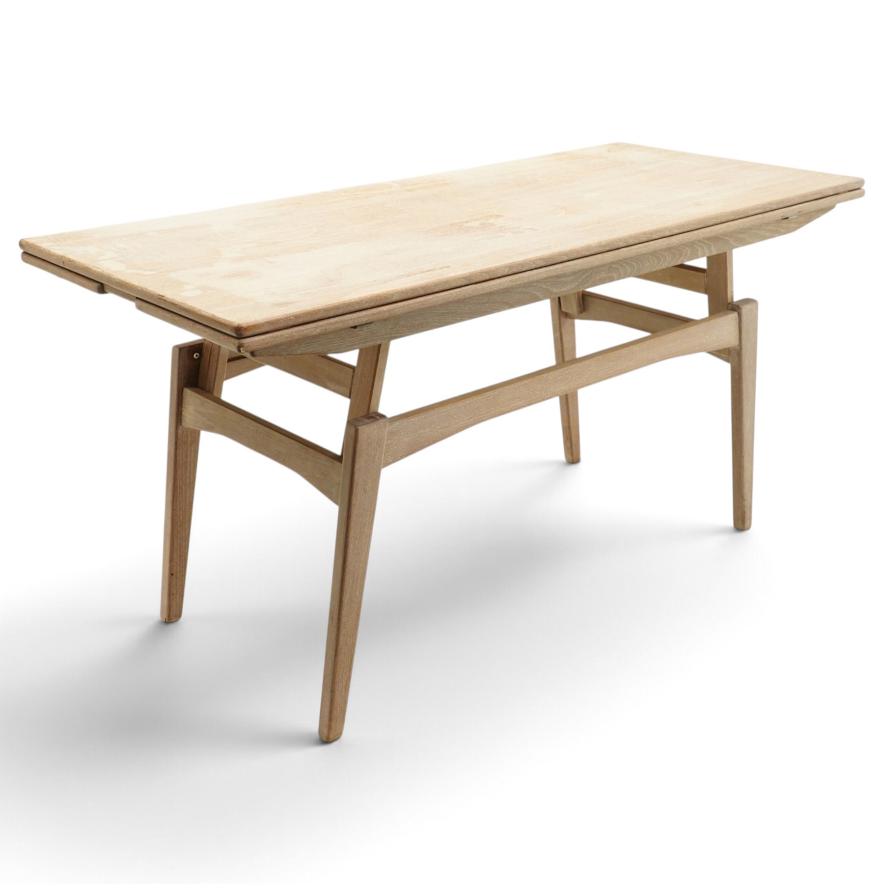 20th century Scandinavian limed oak metamorphic dining-to-coffee table, the rectangular extending top with draw-leaf sides, over an adjustable-height action base, on splayed supports united by stretchers
