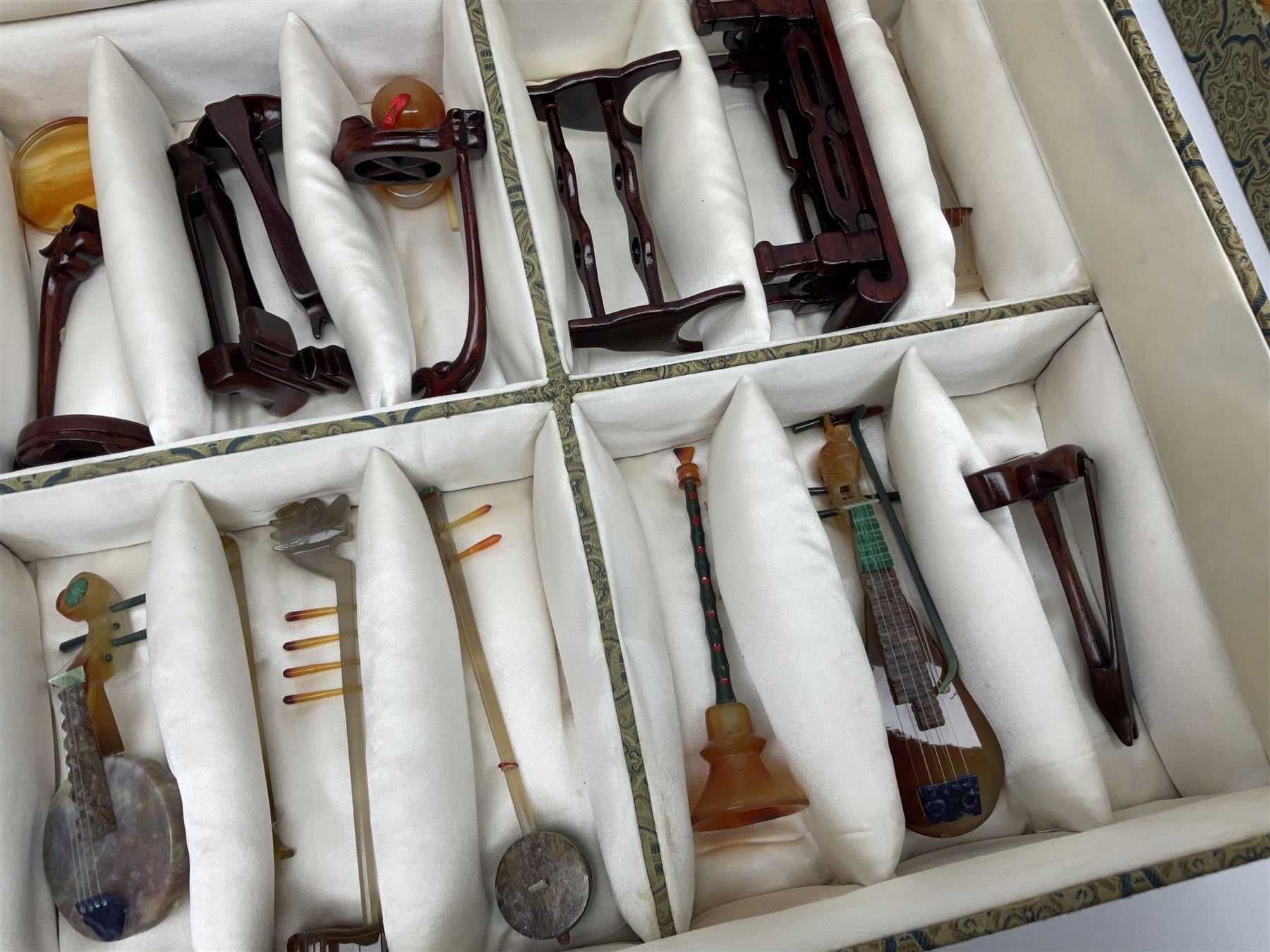 Chinese boxed collection of miniature polished hardstone musical instruments with hardwood stands