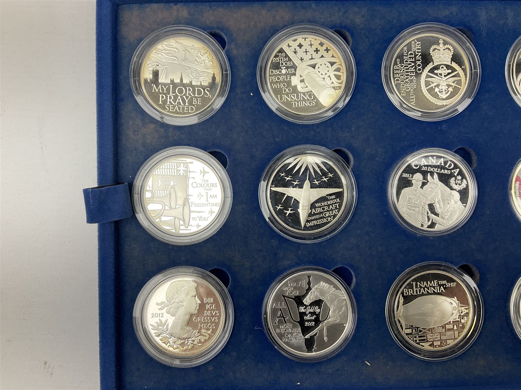 The Queen's Diamond Jubilee silver proof coin collection, consisting of twenty-four coins from Commonwealth countries, produced by The Royal Mint, housed in a blue presentation case, with certificate stating this is number 1397 of 15000 produced