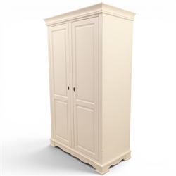 Modern white painted double wardrobe, fitted with two panelled doors, enclosing a hanging rail and shelving, raised on bracket feet