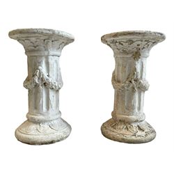 Pair of cast stone classical design pedestals, circular top over fluted body decorated with bellflower festoons, circular base moulded with leaf decoration 