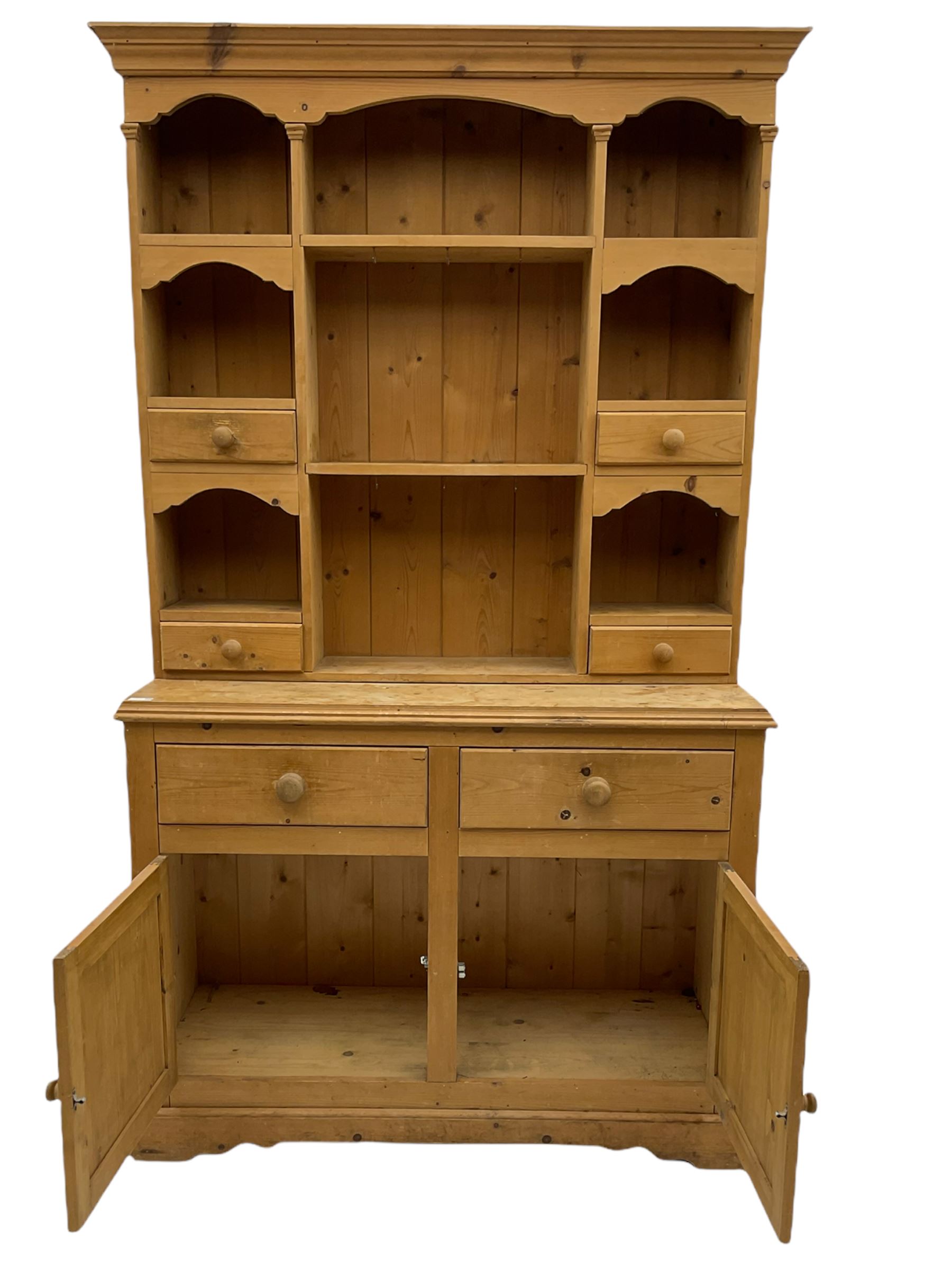 Solid pine dresser, raised plate rack fitted with small drawers over two drawers and double cupboard, plinth base