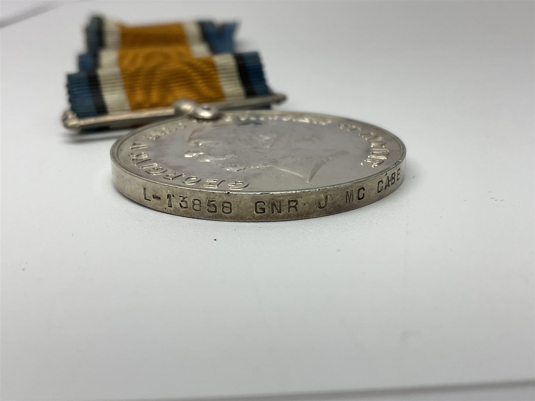 WW2 German Luftwaffe Mess cutlery comprising table spoon and fork, each with H.M.Z.38 mark; WW1 British War Medal awarded to L-13858 Gnr. J. McCabe R.A.; and small quantity of military badges, rank pips etc