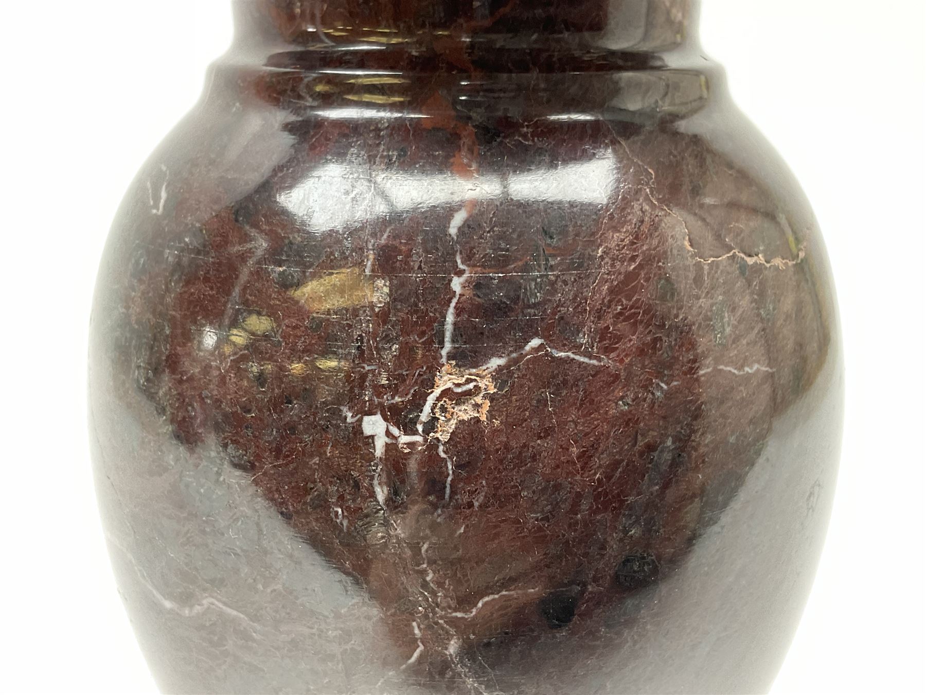 Red marble vase, of baluster form upon a stepped foot, H20cm 