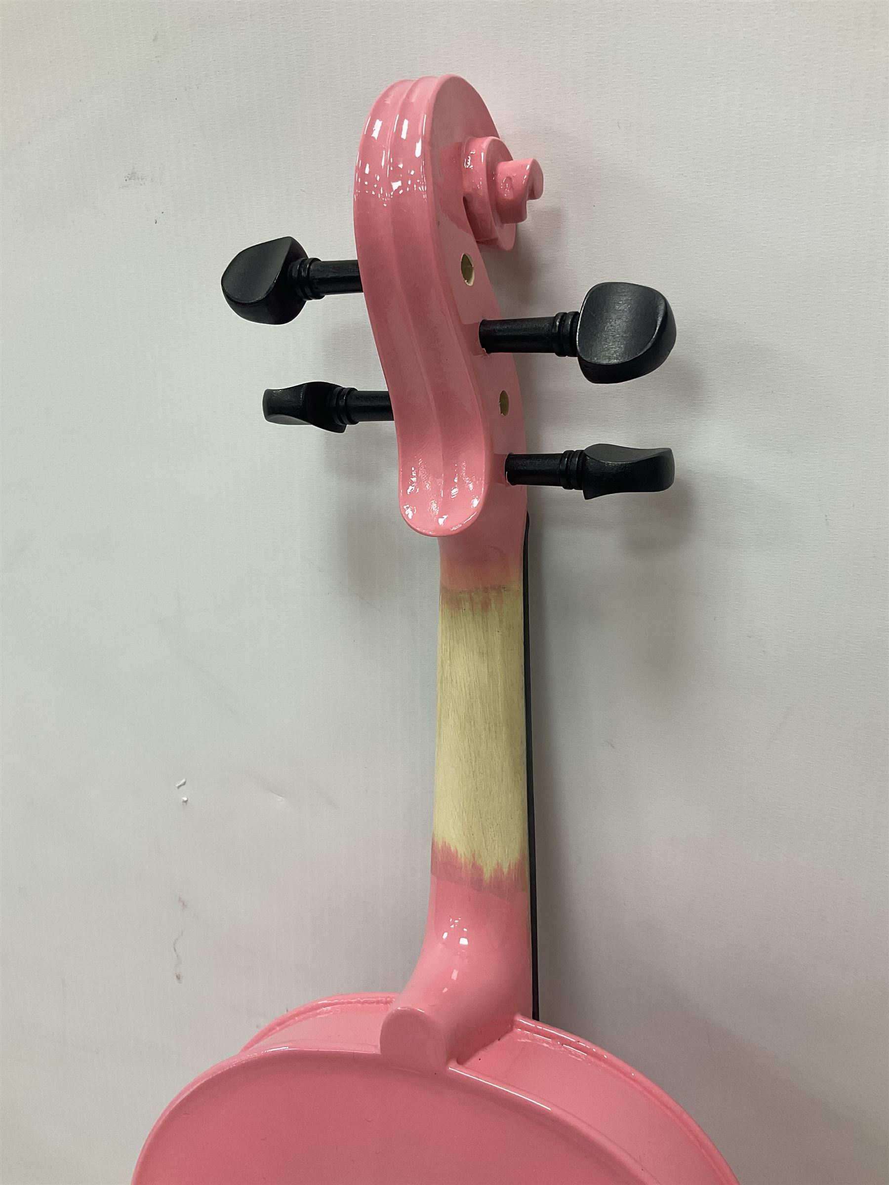 Zest full size pink violin, with a solid wood body and maple head, with matching pink bow and two further bows, in a hard case Length 60cm