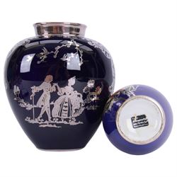 Heinrich vase with silver overlay depicting figures in period dress upon a cobalt blue ground, together with German vase with floral decoration and silver overlay, largest H21cm 