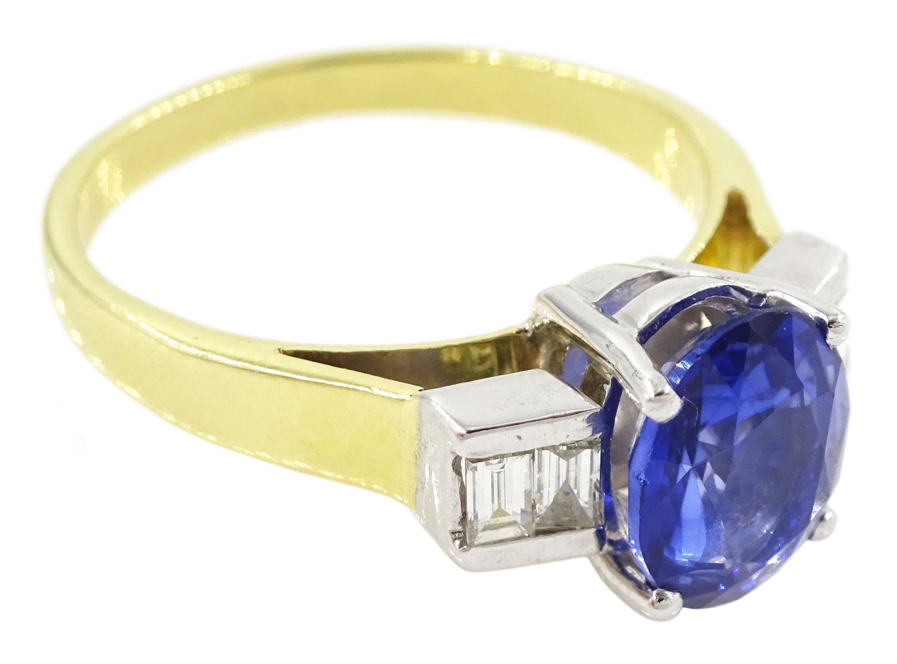 18ct gold tanzanite and diamond ring, single stone oval cut tanzanite of approx 1.75 carat, with two baguette cut diamonds set either side, stamped 750