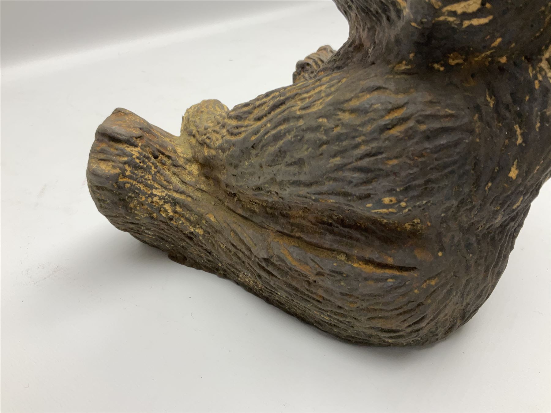 19th century cast iron door stop, modelled as a seated toy bear, with remnants of painted finish, H22.5cm