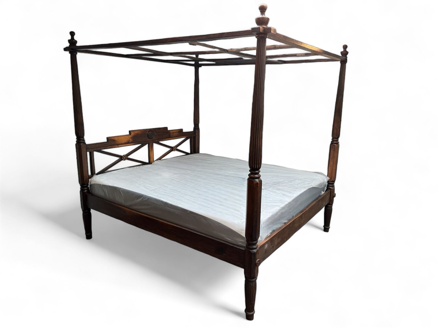 Georgian design Indian sheesham hardwood framed four poster bed, lattice slats to the top supported by reeded cylindrical and octagonal column uprights, the pierced stepped headboard carved with floral motifs, with associated mattress