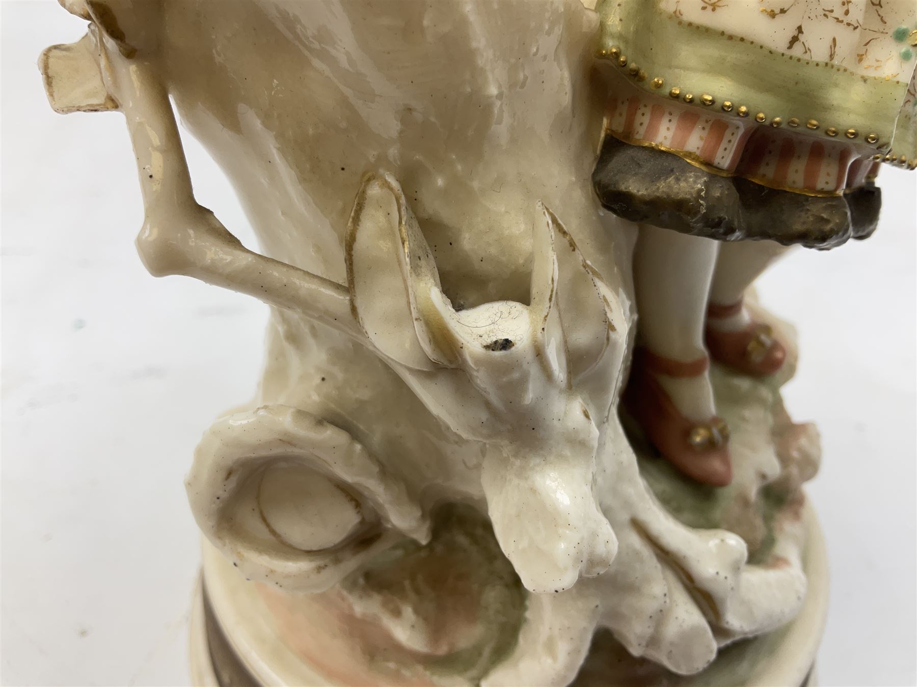 Late 19th century continental spill vase as a young girl standing beside an open tree trunk H21cm; and three German bisque figures (4)