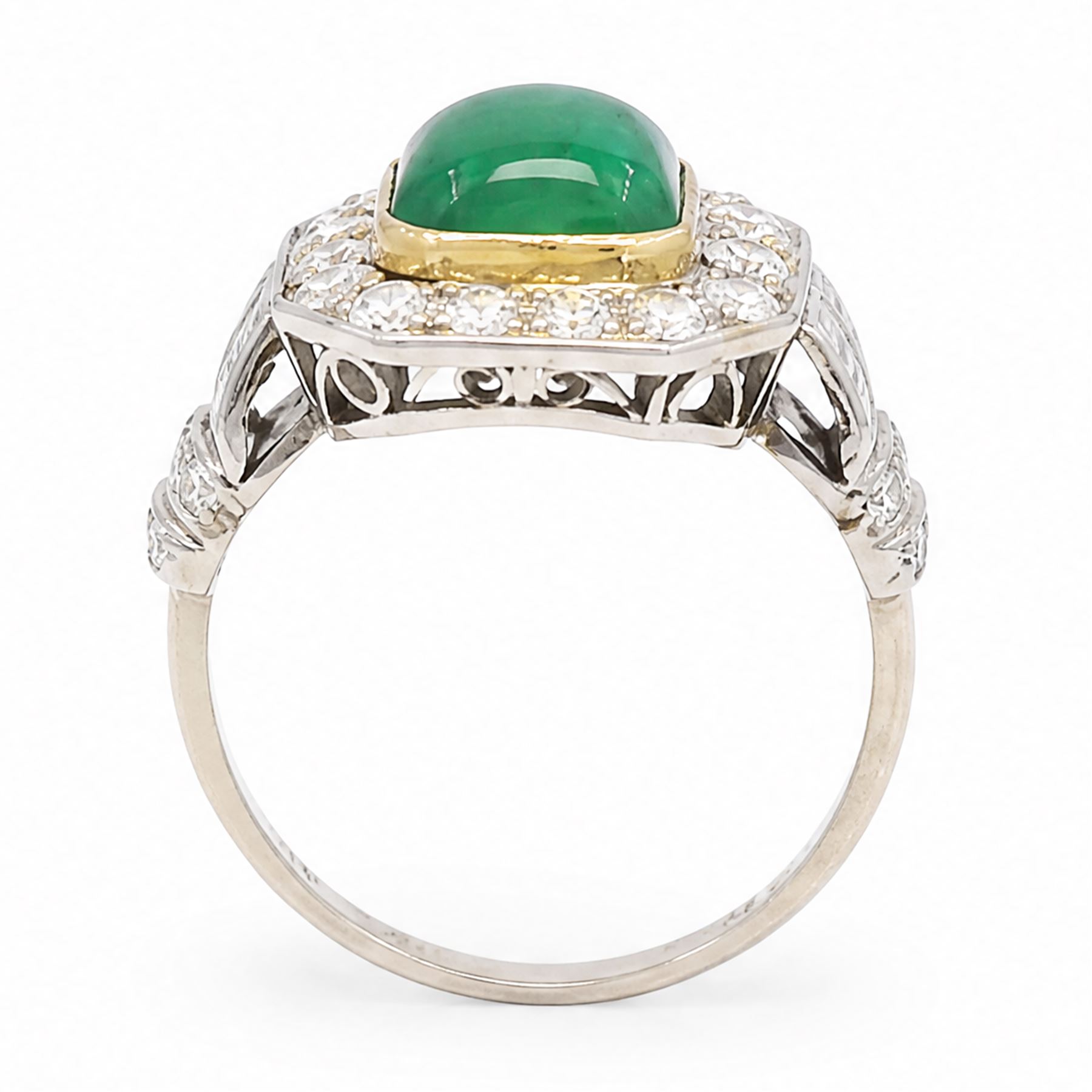 18ct white gold and platinum emerald and diamond cluster ring, single octagonal cabochon cut emerald, surrounded by sixteen milgrain set round cut diamonds, the shoulders set with baguette and single cut diamonds, stamped 18ct, total diamond weight approx 1.55 carat