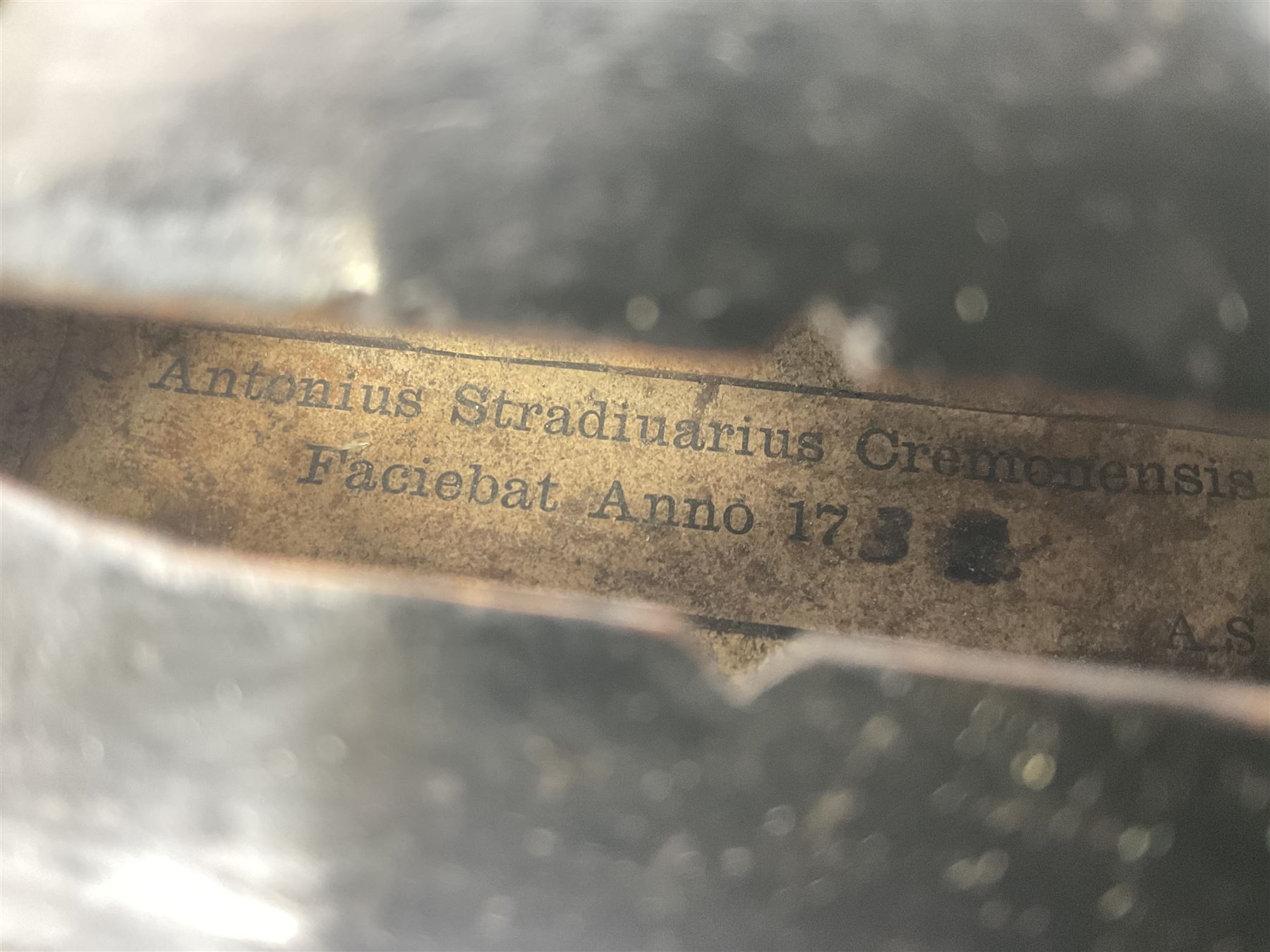 German violin c1890 with 36cm two-piece maple back and ribs and spruce top; bears label 'Antonius Stradivarius Cremona Faciebat Anno 1729' L59.5cm overall; in ebonised wooden 'coffin' case; and two German violins c1890 for completion - one bearing a Stradivarius label, the other a Ruggeri label; both in carrying cases (3)