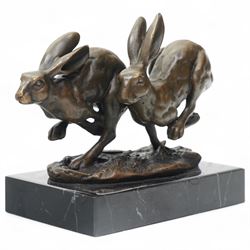 Bronze figure group modelled as two hares in chase, signed Nick and on marble base H12cm