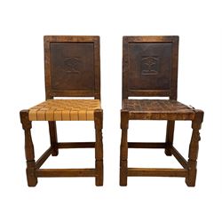 Mouseman - circa. 1930s set of six (4+2) oak dining chairs, panelled back carved with the Bagshawe family crest, the moto 'Forma Flos Fama Flatus' over an arm grasping a bugle-horn with ribbon tie and Yorkshire rose motif, adzed frame, leather lattice strap seat, on octagonal supports united by stretchers, two carvers and four side chairs, each carved with mouse signature, by Robert Thompson of Kilburn 

Provenance: Owned since manufacture by the Bagshawe family, descendants of the Staithes Group Artist Joseph Richard Bagshawe RBA (1870-1909).