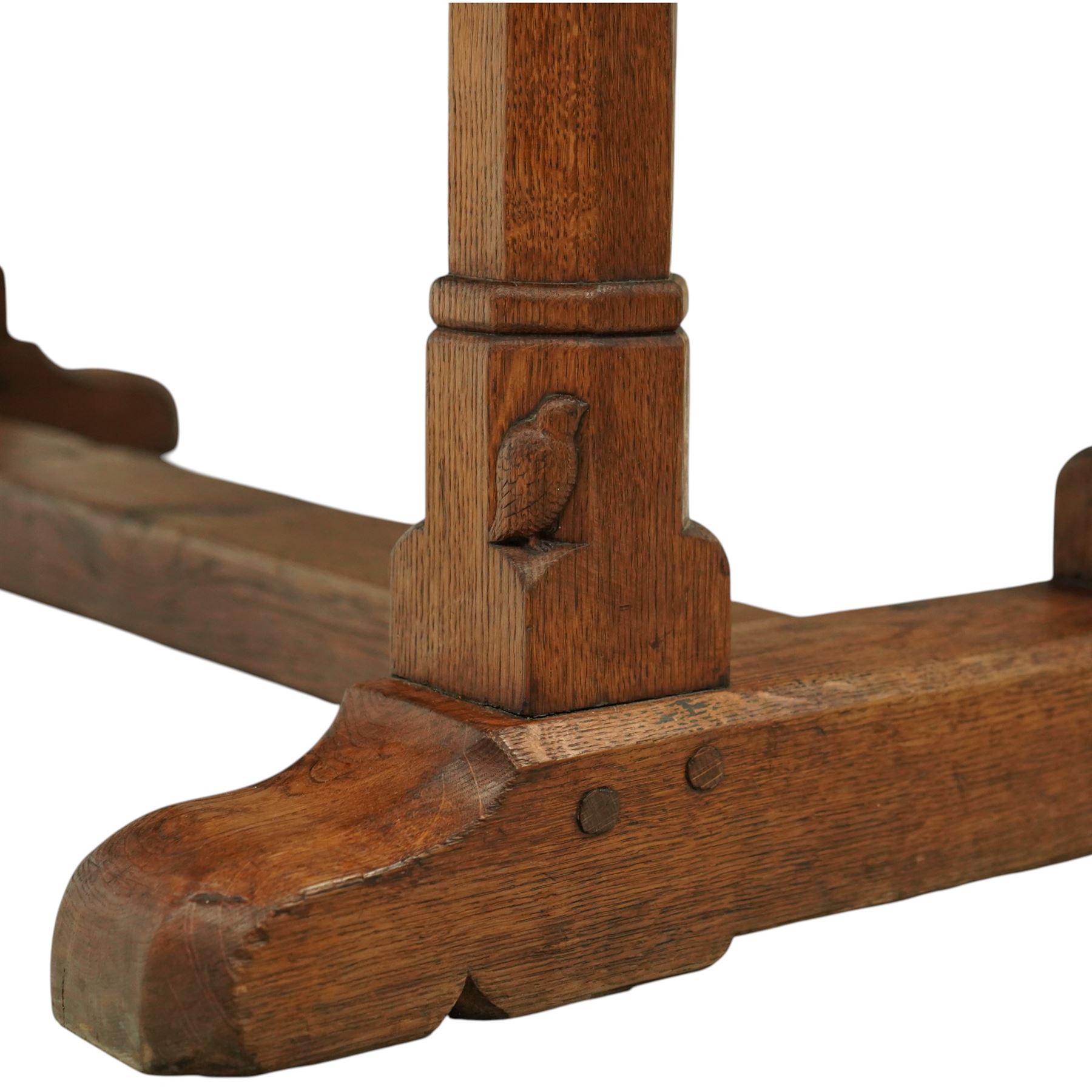 Mouseman - 1937 refectory table, Sir Herbert Baker commission for Westminster Church House, the rectangular adzed plank top above twin octagonal baluster supports united by a pegged stretcher, raised on shaped sled bases carved with a partridge and a loaf of bread, with carved mouse signature to inside leg, by Robert Thompson of Kilburn

The carved loaves reference the original patron, while the partridges are thought to represent Frank Partridge, Bishop of Portsmouth from 1877 to 1941, who played a key role in the founding of Church House and served as its Secretary from 1936 until 1941

Reference
Christie’s ROBERT “MOUSEMAN” THOMPSON; Refectory Table, Lot 188, sold at Christie’s London, commissioned by Sir Herbert Baker KCIE, RA, architect of Church House (opened 1937). Provenance and description available on the Christie’s website
https://www.christies.com/en/lot/lot-4618786