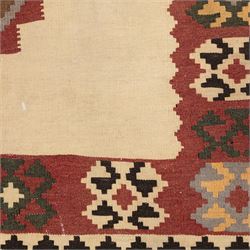 South West Persian Qashqai kilim, woven in flatweave in earthy tones, camel brown, ivory, olive, green, black, and madder red with three bold lozenge-shaped medallions, geometric borders incorporating stepped, hooked, and rosette motifs 