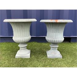 Pair cast iron Campana shaped urns, egg and dart moulded rim, fluted body with gadroom underside, fluted foot support on square bases - THIS LOT IS TO BE COLLECTED BY APPOINTMENT FROM DUGGLEBY STORAGE, GREAT HILL, EASTFIELD, SCARBOROUGH, YO11 3TX