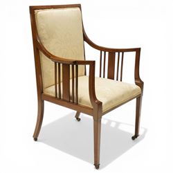 Arts & Crafts period inlaid mahogany framed armchair, swept arms with satinwood-strung supports over back and sprung seat upholstered in cream foliate damask fabric, on square tapering supports with castors