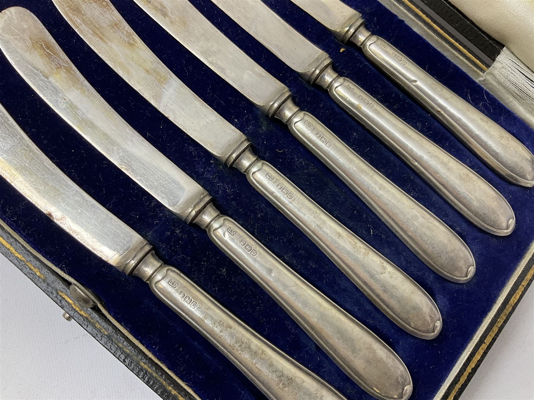 Set of six silver handled butter knives, in case, pair of silver handled fish servers, two silver handled shoe horns, and two silver handled button hooks, all hallmarked or stamped Sterling