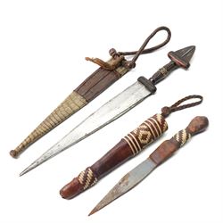 North African arm dagger with leather sheath and one other African dagger (2)
